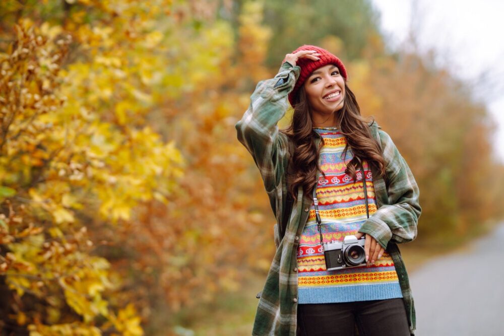 Beautiful young woman being photographed with a retro camera. Rest, relaxation, travel, lifestyle concept